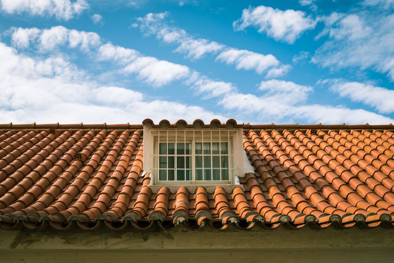 Crafting Captivating Headlines: Your awesome post title goes here Close-up of a terracotta tiled roof with a skylight window in sunny Marbella, Spain.